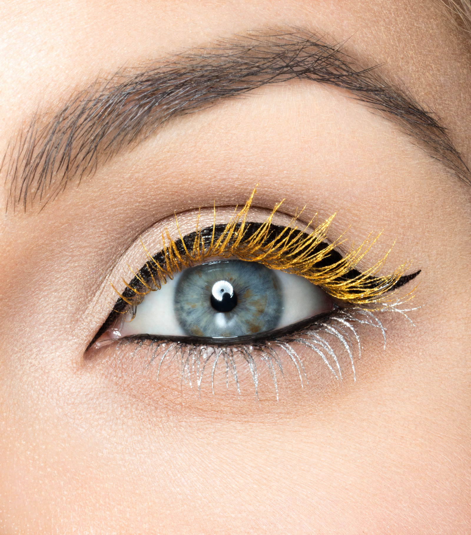 Macro beauty photograph of an Urban Decay mascara eye look in gold