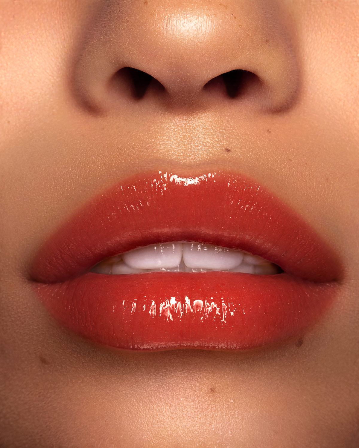 Beauty photograph of Pat McGrath Labs LUST: Gloss in Flesh, high gloss lip